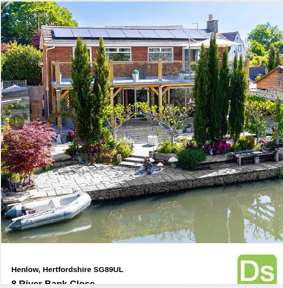The opening page of a D&rsquo;sign brochure: a large photograph of a red brick house behind a garden on a river bank, with the address printed underneath