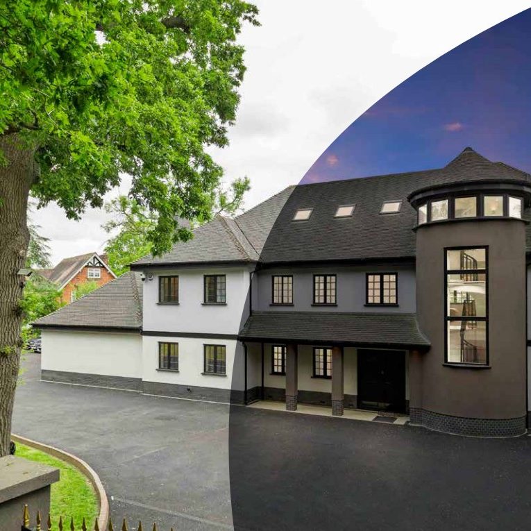 A large refurbished house shown half in daylight and half at dusk, the two versions meeting along a curve